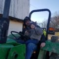 Jason and son in tractor.