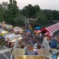 People, tents, stands at Loudonville fair.