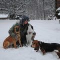 Jason in snow with 3 dogs.